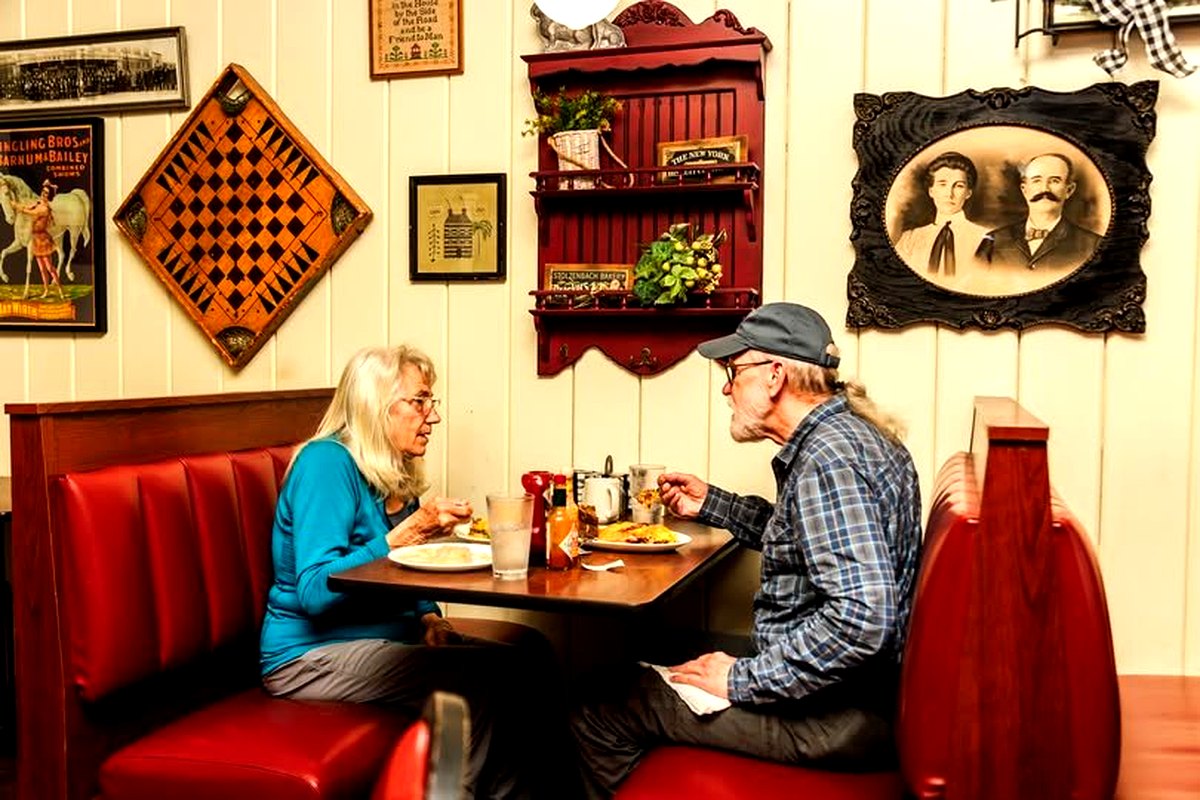 Guests enjoying breakfast together at Cook's Kitchen — the community atmosphere that makes it home